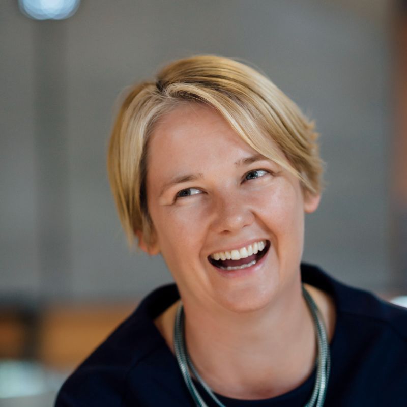 Profile photo of Katherine Kemp laughing and looking towards the right. 