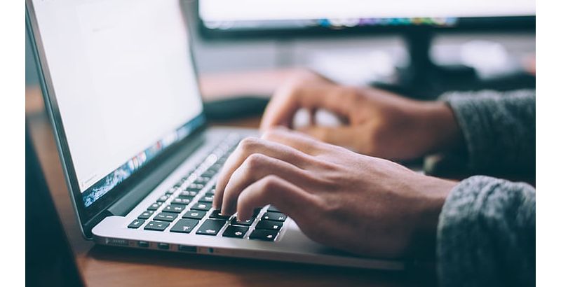 Close-up shot of fingers typing on keyboard