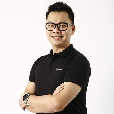 a headshot of an asian man smiling 