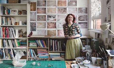 Hannah Bertram - smiling woman standing in creative studio library