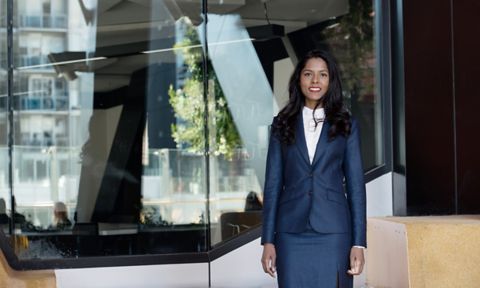 Hema Zmirak - Smiling woman in a corporate suit