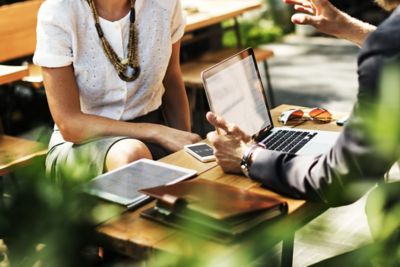 A man and a woman in a meeting with a laptop