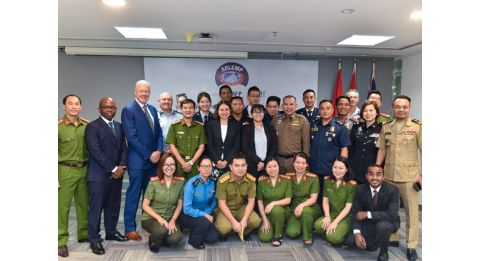 transnational security centre team and police posing in a room