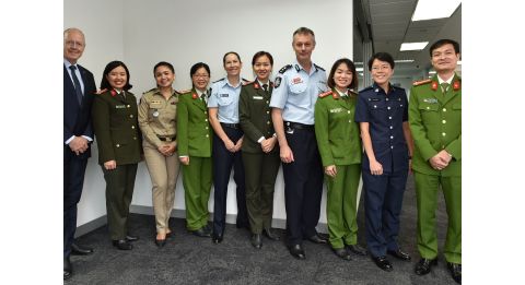 transnational security centre team and police posing in a room