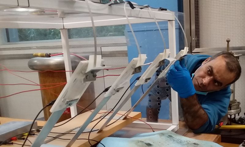 Dr Tariq Nazir conducts an electrical discharge experiment on the various insulation material test samples. Credit: Supplied by the research team 