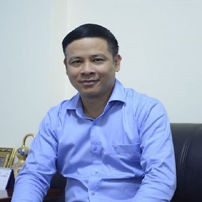 a headshot of an asian man smiling 