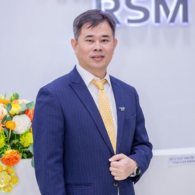 a headshot of an asian man in suit smiling 