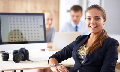 Female smiling with arm rested at desk