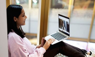 Girl sitting at laptop smiling