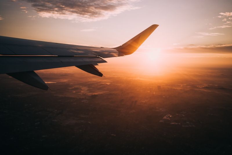 The sky view with clouds and the sun from a flying plane