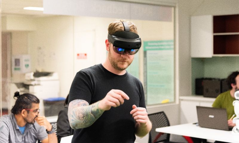 An RMIT computer science student using an augmented reality headset in a class.