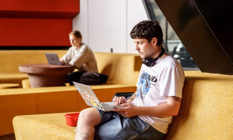 A student looking at a laptop with a concerned look on their face