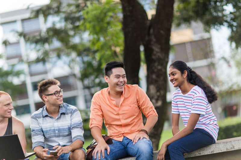 A group international students sitting together smiling