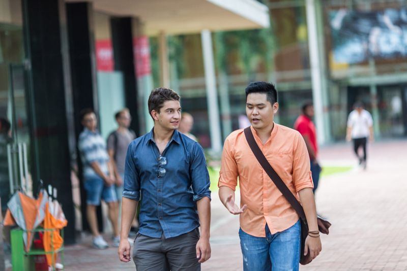 Two students walking and talking in RMIT