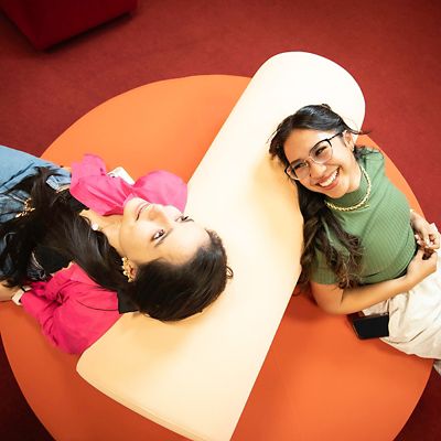 Two RMIT UP  female students on orange couch