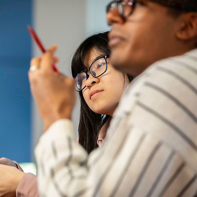 female student with glasses looking away from camera