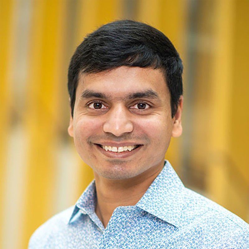 Sharath Sriram profile photo he is wearing a blue button up shirt and smiling