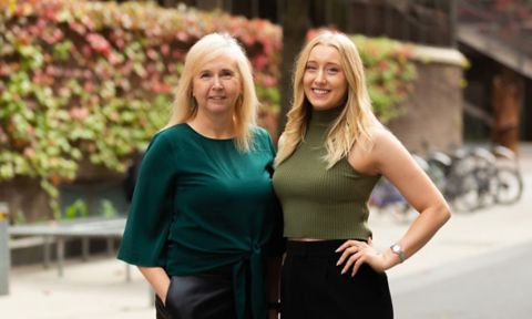 Sharyn Lowe and Ellen Weigall stand together smiling on Bowen Street at RMIT's City Campus.