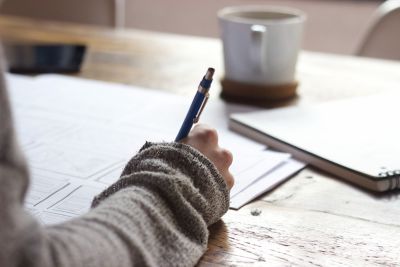 Students hand writing with a pen