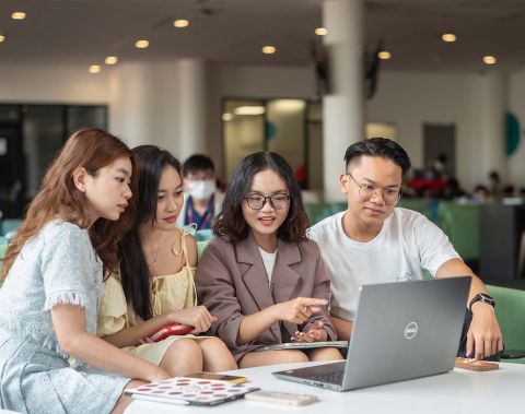 four students discussing work 