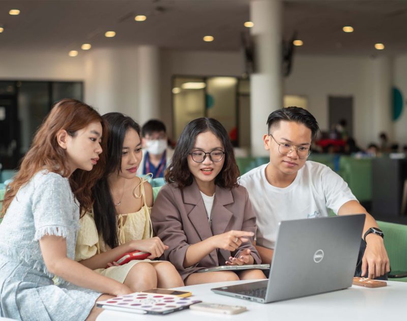 four students discussing work 