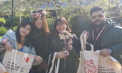 Four smiling international students at an open day