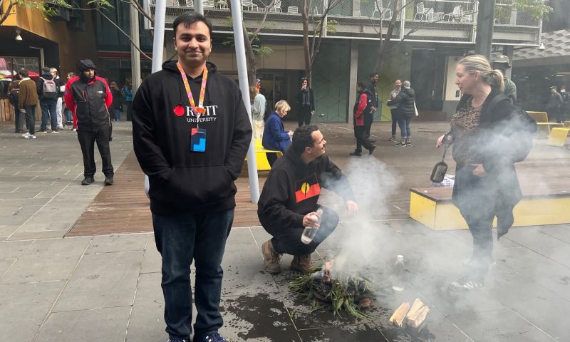 Student standing next to smoking ceremony