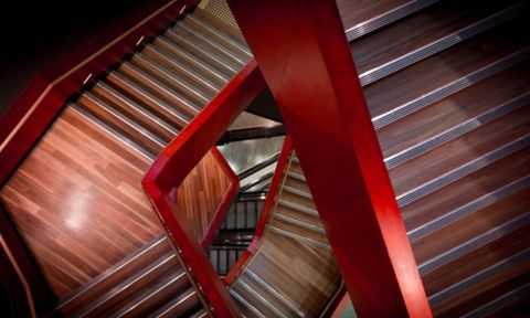 Red and wooden staircase viewed from above