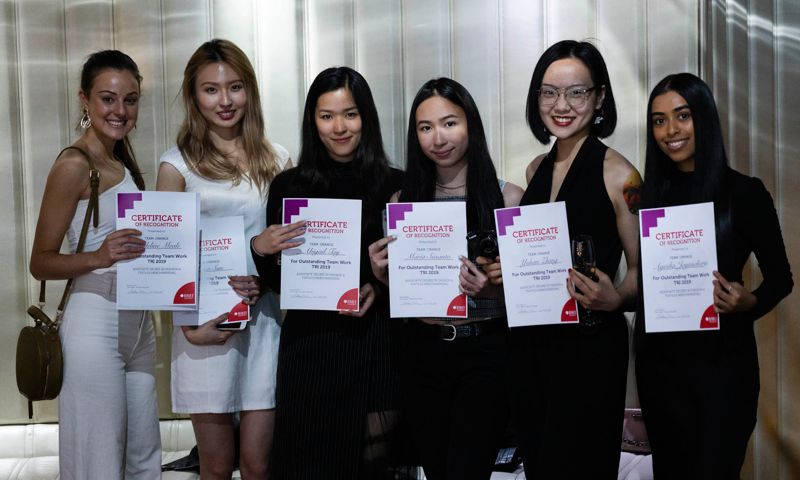 VE Fashion students stand with their Teamwork recognition awards at the end of year ceremony