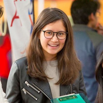 A student smiles at the camera during an orientation event.