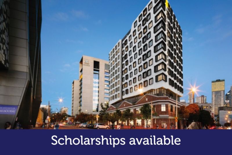 A skyscraper features on a busy street.