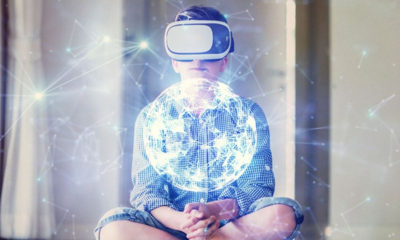 Child wearing virtual reality headset with abstract bright globe image overlay