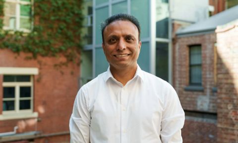  Rajeev smiles at the camera.
