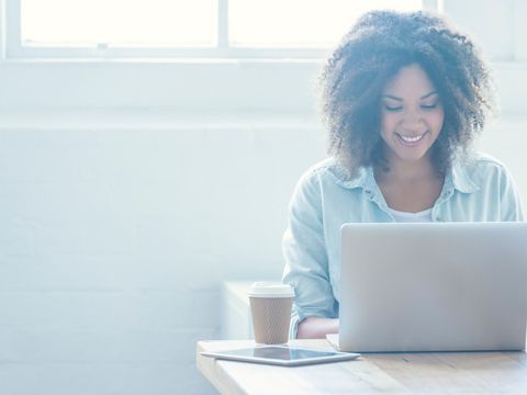 Women uses her laptop at a table.