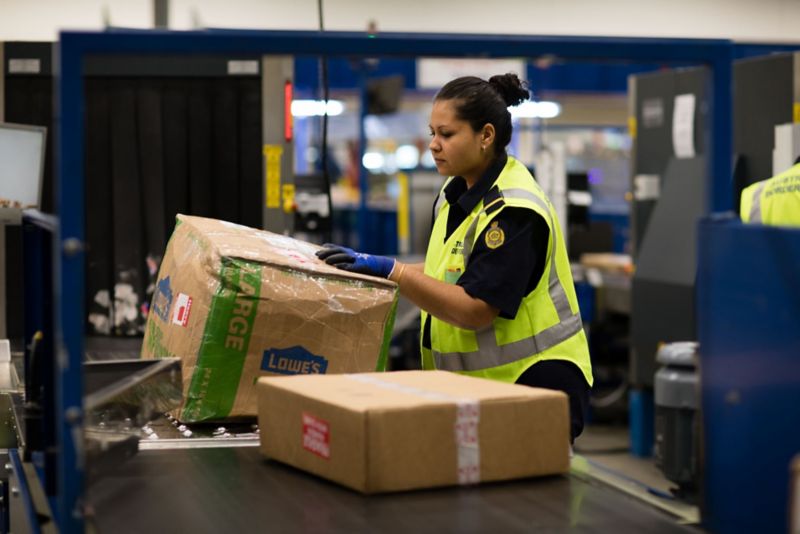 a security guard checking a package 