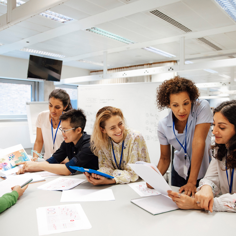 Teacher with a group of university students in a classroom