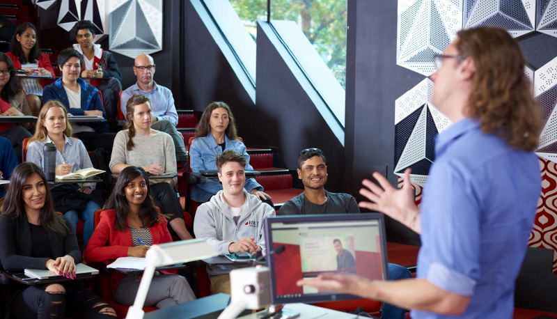 A man lecturing a class of students