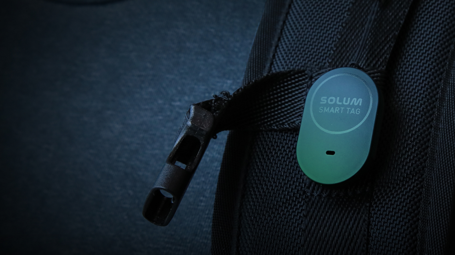 Smart tag clipped to a backpack strap.