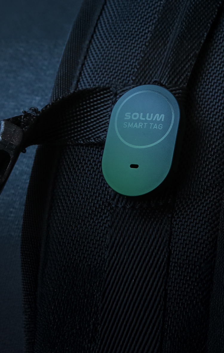 Smart tag clipped to a backpack strap.