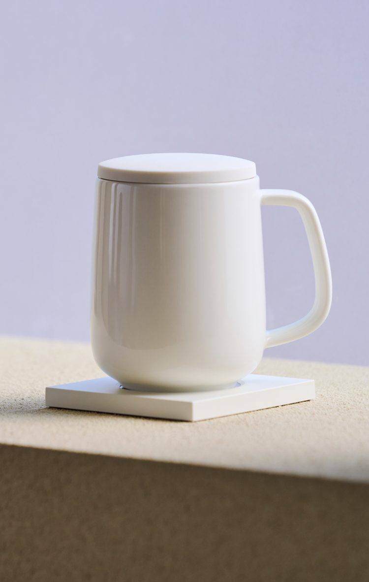 Ceramic mug on a smart warmer base.
