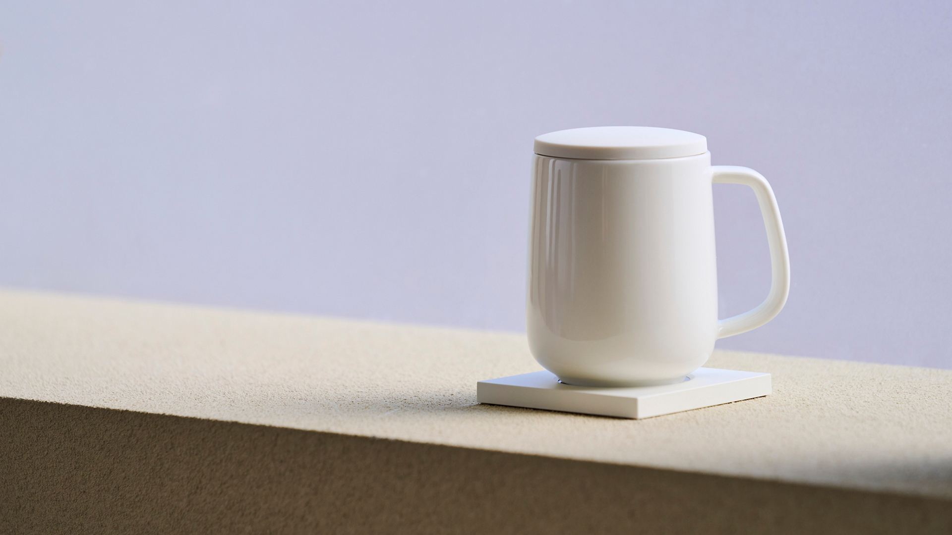 Ceramic mug on a smart warmer base.