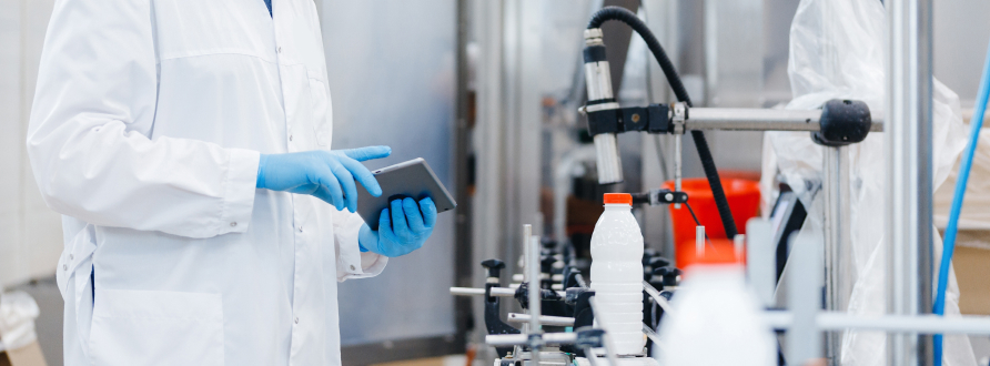 Worker measuring temperature in a factory.