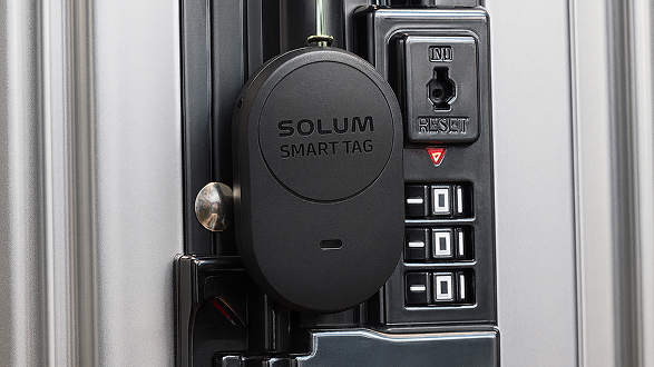 Smart tag attached to a suitcase lock.