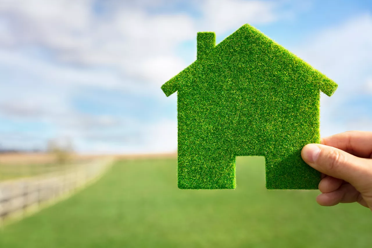 Green ecological house in empty field concept for construction and real estate