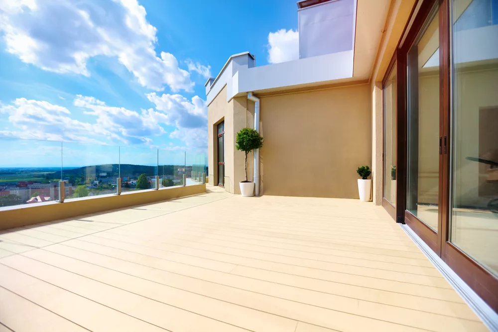 a terrace on upper floor with sliding doors
