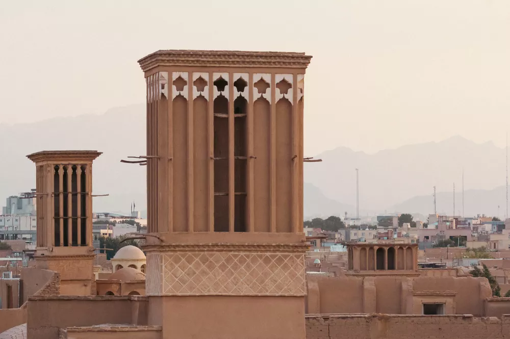 Two wind catchers or ventilation towers made with adobes, a genius way to cool down the heat of hot summers with power of nature. Yazd, Iran.