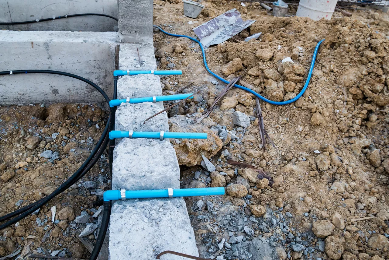 Pest control pipe system install at new house construction foundation for termite protection
