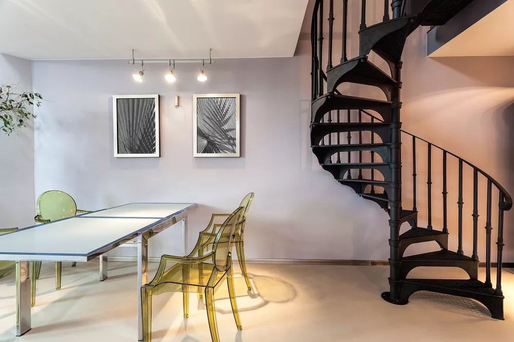 Metal staircase and a plastic chairs and table