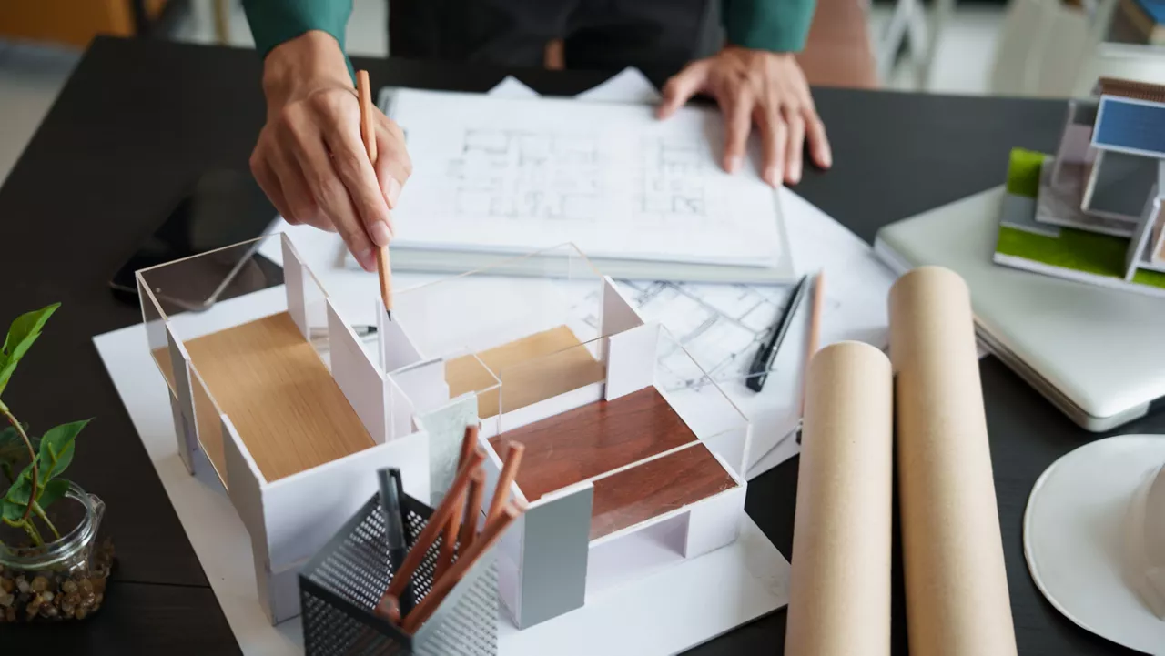 Architecture Man drawing on architectural Creative project business architecture building construction Industrial engineering Achievement Planning Design on eco blueprint