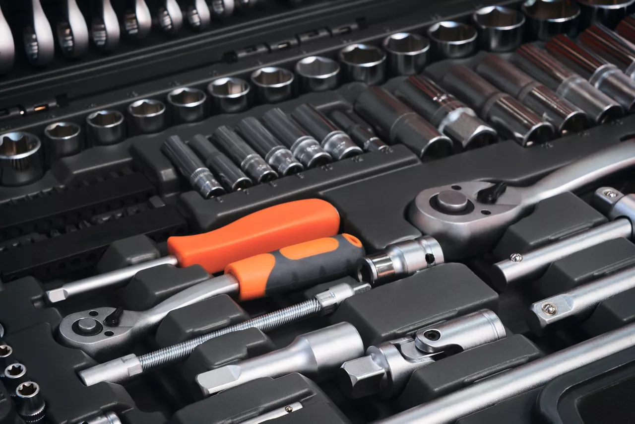 A toolbox with many different tools including pliers, wrenches, and screwdrivers. The tools are organized in a way that makes it easy to find what you need